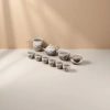 The celadon tea set includes a teapot, fair cup, tea cups, tea bowls, tea saucers, and an orange blossom branch painted beige gift box details Picture